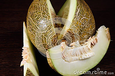 Sliced melon on dark wooden table Stock Photo