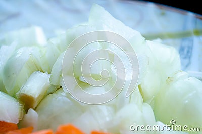 Sliced onions. A plate with vegetables. Diced onions close-up. Healthy diet. Proper nutrition. Vegetables. Natural products. Stock Photo