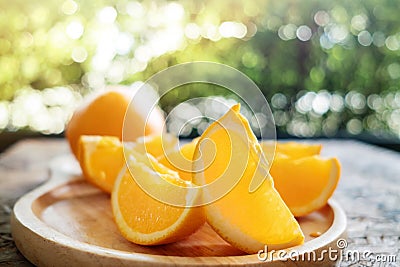 Sliced Orange on Wooden Plate. Fresh Juicy Fruit in Summer. Selective Focus Stock Photo