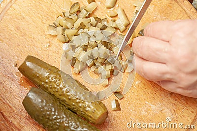 sliced pickle on the kitchen board. preparation of the ingredient for the dish. homemade cooking. slicing process Stock Photo