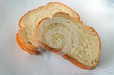 Slices of golden bread on a light background Stock Photo