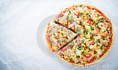 Sliced pizza with mozzarella cheese, chicken, sweet corn, sweet pepper and parsley on white background top view Stock Photo