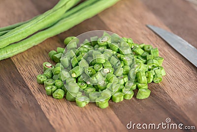 Sliced raw long bean on wood cutting board. Stock Photo