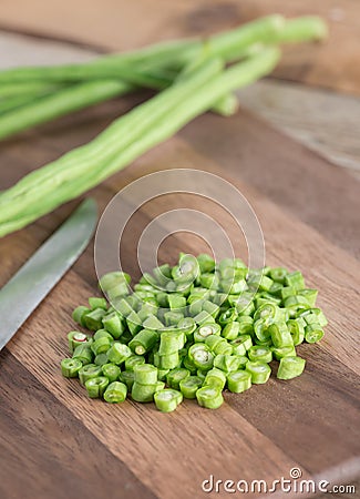 Sliced raw long bean on wood cutting board. Stock Photo