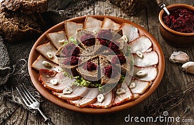 Sliced salted lard and bacon with rye bread, horseradish, spices on plate on rustic wooden background. Appetizer, close up Stock Photo