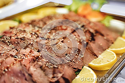 Sliced seasoned roast beef on a buffet table Stock Photo