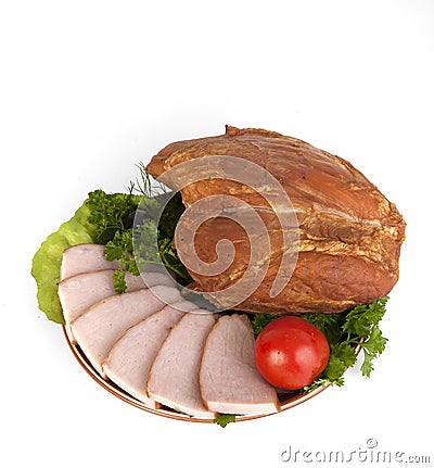 Sliced smoked meat on a plate with greens. Stock Photo