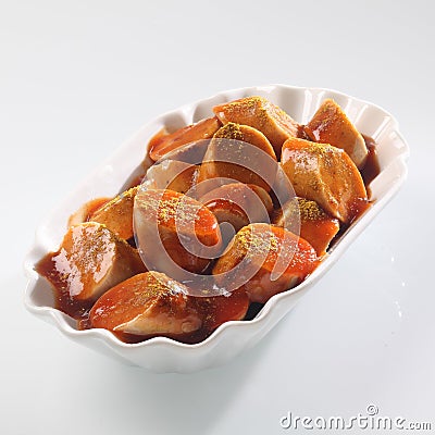 Sliced spicy sausage in tomato sauce Stock Photo
