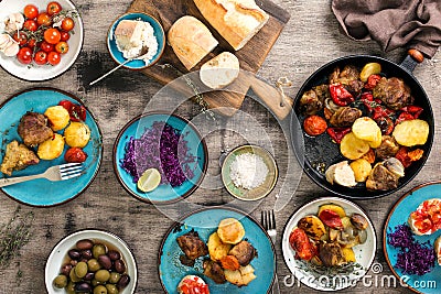 Sliced steak with grilled vegetables and sauce on wooden board Stock Photo