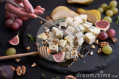 Sliced Traditional Italian Gorgonzola cheese on stone seving board Stock Photo