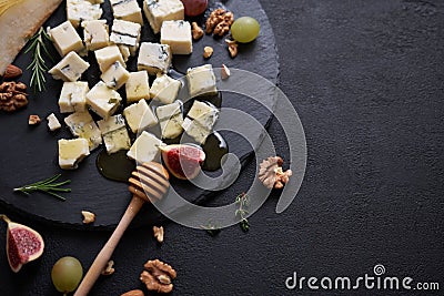 Sliced Traditional Italian Gorgonzola cheese on stone seving board Stock Photo