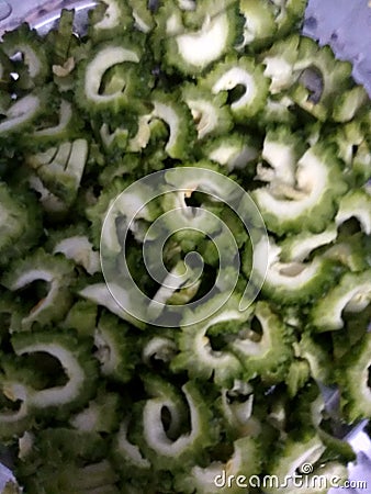 IT IS SLICED VEGETABLE WHIGH REDUCED SUGAR LAVEL IN THE HUMAN BODY . IT IS A VEGETABLE WHICH IS KNOW AS BITTER GOURD. Stock Photo