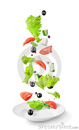 Sliced vegetables and salad ingredients falling in white ceramic plate isolated Stock Photo