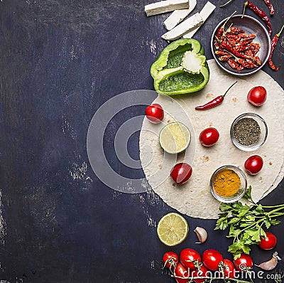 Sliced vegetables on tortilla, Ingredients for cooking burritos border with text area on wooden rustic background top view vertic Stock Photo