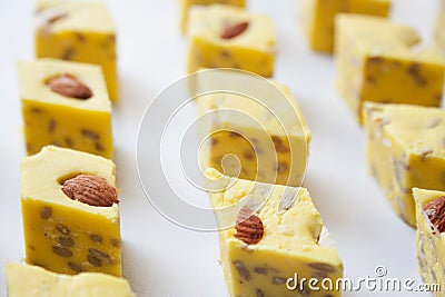 Sliced yellow halva with melon taste and almond nuts Stock Photo