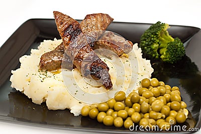 Slices of beef mashed potato, peas and broccoli Stock Photo