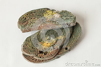 Slices of black bread covered with mold on a white background Stock Photo