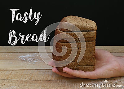 Slices of black bread in hand Stock Photo