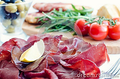 Slices of Bresaola on a plate Stock Photo