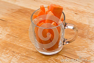 Slices carrots in transparent glass cup Stock Photo