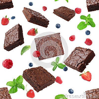 Slices of delicious chocolate brownie with fresh berries and mint flying on white background Stock Photo