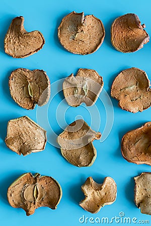 slices of dried apple on blue background. Shallow depth of field. Homemade sun-dried organic apple slices. vertical photo Stock Photo