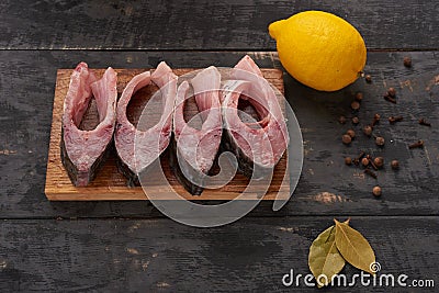 Slices of fresh fish, spices and lemon Stock Photo