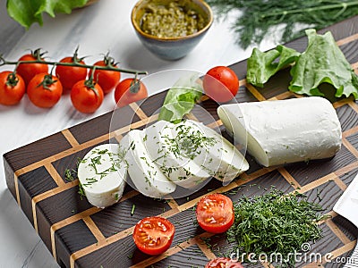 Slices of mozzarella cheese with green dill Stock Photo