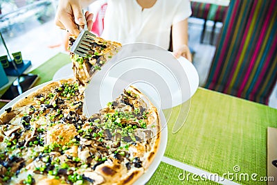 slices of pizza. Table with pizza in a restaurant. Pizza close up on a green Stock Photo