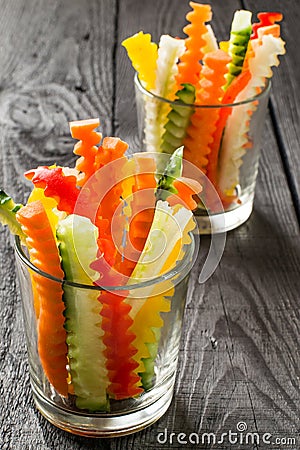 Slices of raw vegetables in glasses Stock Photo