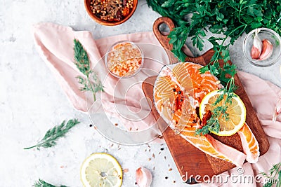 Slices of red fish with rosemary branch, on the cutting board Stock Photo