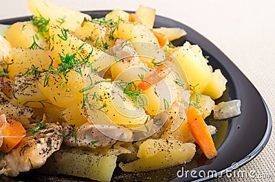 Slices of stewed potatoes, chicken, carrot and onion Stock Photo