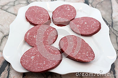 Slices of sucuk sujuk sausage isolated on white background . Stock Photo