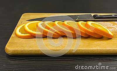 Slices of sweet orange on a chopping board. Stock Photo