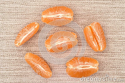 Slices of tangerine, clementine or mandarin orange on the table Stock Photo