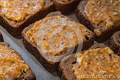 Slices of toasted bread covered with a mixture of egg and feta cheese Stock Photo