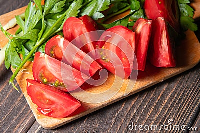 Slices tomatoes served with greenery Stock Photo