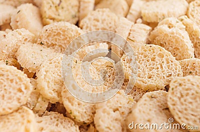 Slices wheat beige spicy croutons as background, closeup. Stock Photo