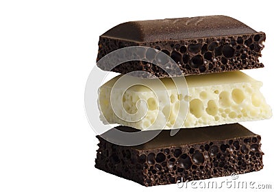 Slices of white and black porous chocolate on a white background Stock Photo