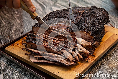 slicing a beef brisket fresh off of the smoker Stock Photo