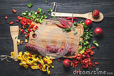 Slicing sausage on cutting Board with ingredients Stock Photo