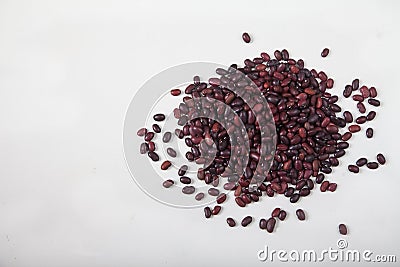 A slide of red raw beans sprinkled on a white background. Healthy lifestyle. Copy spaes Stock Photo