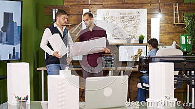 Slide view of focus transition with architects holding blue prints Stock Photo