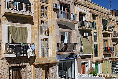 SLIEMA, MALTA - NOVEMBER 5TH 2019 :Traditional multicoloured wooded balcony windows overlook the road in the back streets of Malta Editorial Stock Photo