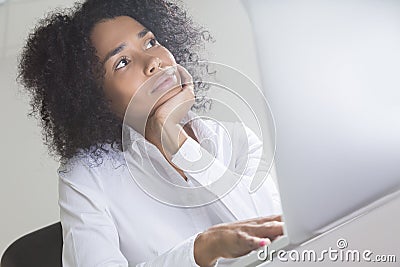 Slightly bored office employee from Africa Stock Photo