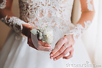 Slim beautiful young bride holding a boutonniere Stock Photo