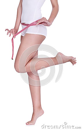 Slim female figure with measuring tape Stock Photo