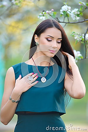 Slim model posing showing a collection of jewelry in the spring Stock Photo