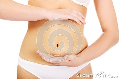 Slim woman belly with hand on it Stock Photo