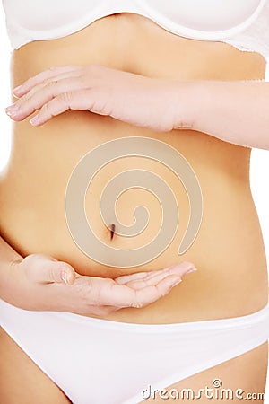 Slim woman belly with hand on it Stock Photo